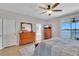 Comfortable bedroom with neutral walls, sliding glass doors to patio, hardwood floors, and furniture at 8251 118Th Ave # 8251, Largo, FL 33773