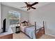 Bedroom featuring a traditional four-poster bed, ceiling fan, and natural light at 8251 118Th Ave # 8251, Largo, FL 33773