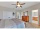 Spacious bedroom featuring hardwood floors, furniture, and a view of the ensuite bathroom at 8251 118Th Ave # 8251, Largo, FL 33773