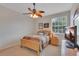 Bedroom featuring wooden furniture, ceiling fan, and natural light at 8251 118Th Ave # 8251, Largo, FL 33773