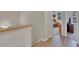 Upstairs hallway with wood floors leading into carpeted bedrooms with lots of natural light and closet space at 8251 118Th Ave # 8251, Largo, FL 33773