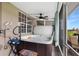 Relaxing screened in hot tub on the patio with a ceiling fan and space for lounging nearby at 8251 118Th Ave # 8251, Largo, FL 33773