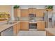 Bright kitchen featuring wood cabinets, stainless steel appliances, and light countertops at 8251 118Th Ave # 8251, Largo, FL 33773