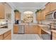This kitchen offers wood cabinets, stainless steel appliances, and an open view of the living area at 8251 118Th Ave # 8251, Largo, FL 33773