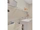 Bright laundry room with a utility sink, washer, dryer and shelving for storage and organization at 8251 118Th Ave # 8251, Largo, FL 33773