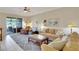 Comfortable living room with a sliding glass door opening to the patio and a view of the lake at 8251 118Th Ave # 8251, Largo, FL 33773