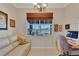 This office features a desk and comfortable sofa with a stunning view of the lake at 8251 118Th Ave # 8251, Largo, FL 33773