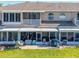 Rear exterior of property featuring patios, green space, and outdoor seating for comfortable, relaxed living at 8251 118Th Ave # 8251, Largo, FL 33773