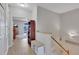 Bright upstairs hallway featuring hardwood floors, staircase with white railing, and an open view of the Gathering room at 8251 118Th Ave # 8251, Largo, FL 33773