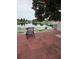 A tranquil patio with a chair and a serene lake view at 8718 Lindenhurst Pl, Tampa, FL 33634