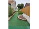 Manicured backyard with artificial turf and landscaping at 8718 Lindenhurst Pl, Tampa, FL 33634