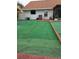 Spacious backyard featuring artificial turf and patio area at 8718 Lindenhurst Pl, Tampa, FL 33634