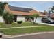 Charming single-story home with well-manicured lawn and solar panels on the roof at 8718 Lindenhurst Pl, Tampa, FL 33634
