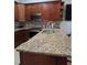 Close-up of kitchen featuring granite countertops and stainless steel appliances at 8718 Lindenhurst Pl, Tampa, FL 33634