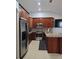 Well-equipped kitchen with granite countertops, stainless steel appliances, and ample cabinet space at 8718 Lindenhurst Pl, Tampa, FL 33634