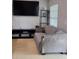 Casual living space featuring tile floors and wall-mounted television at 8718 Lindenhurst Pl, Tampa, FL 33634