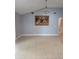 Spacious living area with tile floors, vaulted ceilings, and elegant chandelier at 8718 Lindenhurst Pl, Tampa, FL 33634
