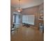Bright living room featuring tile floors, large window, and elegant chandelier at 8718 Lindenhurst Pl, Tampa, FL 33634