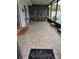 This screened patio has pavers, a table, and an outdoor kitchen area; ready for entertaining and relaxation at 8718 Lindenhurst Pl, Tampa, FL 33634