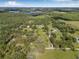 An aerial view showcases the property nestled within lush trees, offering privacy and a serene atmosphere at 8843 Kenton Rd, Wesley Chapel, FL 33545