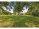 Large backyard with mature trees provides ample space for outdoor activities and leisure at 8843 Kenton Rd, Wesley Chapel, FL 33545