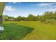 Expansive backyard with vibrant green grass, providing a vast outdoor space for activities and relaxation at 8843 Kenton Rd, Wesley Chapel, FL 33545