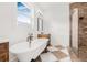 Bright bathroom showcasing a clawfoot tub, a standing shower, and stylish finishes at 8843 Kenton Rd, Wesley Chapel, FL 33545