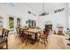 Dining area with high ceilings, large windows, and access to the backyard at 8843 Kenton Rd, Wesley Chapel, FL 33545