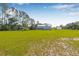 Charming home with a metal roof and lush green surroundings, presenting a picturesque countryside setting at 8843 Kenton Rd, Wesley Chapel, FL 33545
