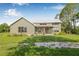 Charming home with a metal roof, covered porch, and a spacious front yard at 8843 Kenton Rd, Wesley Chapel, FL 33545