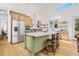 Gourmet kitchen with stainless steel appliances, custom cabinets, and a center island at 8843 Kenton Rd, Wesley Chapel, FL 33545