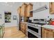 Gourmet kitchen features stainless steel appliances and plenty of custom wood cabinetry for storage at 8843 Kenton Rd, Wesley Chapel, FL 33545