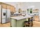 Bright kitchen with stainless steel appliances, custom cabinets, and a center island at 8843 Kenton Rd, Wesley Chapel, FL 33545