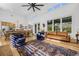 Open concept living and dining area with hardwood floors and large windows at 8843 Kenton Rd, Wesley Chapel, FL 33545