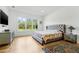 Comfortable main bedroom with natural light, stylish furnishings, and a serene atmosphere at 8843 Kenton Rd, Wesley Chapel, FL 33545