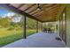 Enjoy outdoor living on this covered patio, complete with dining area and ceiling fans, perfect for entertaining at 8843 Kenton Rd, Wesley Chapel, FL 33545