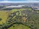 A captivating aerial view showcases outlined property lines encompassing a sprawling landscape and mature trees at 8843 Kenton Rd, Wesley Chapel, FL 33545