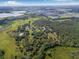 An aerial view of expansive property lines bordering a beautiful estate amidst lush green trees and expansive land at 8843 Kenton Rd, Wesley Chapel, FL 33545