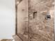 Modern shower with marble-look tile and glass doors at 8843 Kenton Rd, Wesley Chapel, FL 33545