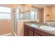 Bathroom features a glass shower, tile surround, and vanity with sink and mirror at 915 Windton Oak Dr, Ruskin, FL 33570