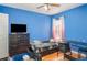 Bedroom featuring blue walls, hardwood floors, and a window with sheer curtains at 915 Windton Oak Dr, Ruskin, FL 33570