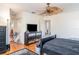 Bedroom featuring hardwood floors, a ceiling fan, closet doors, and a black dresser at 915 Windton Oak Dr, Ruskin, FL 33570