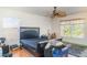 Bedroom with a dark bed frame, ceiling fan, and two windows providing natural light at 915 Windton Oak Dr, Ruskin, FL 33570