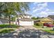 Two-story home boasts a well-manicured lawn and an attached two car garage at 915 Windton Oak Dr, Ruskin, FL 33570