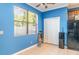 Bright kitchen featuring blue walls, tile floors, and a large window with natural light at 915 Windton Oak Dr, Ruskin, FL 33570