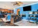 Living room features modern seating and an open-concept layout with access to the kitchen at 915 Windton Oak Dr, Ruskin, FL 33570