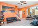 Living room features tiled floors, modern decor, and multiple sofas for ample seating at 915 Windton Oak Dr, Ruskin, FL 33570