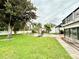 Expansive backyard with a well-maintained lawn, mature trees, and a refreshing pool area at 945 College Hill Dr, Clearwater, FL 33765