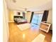 Bedroom featuring hardwood floors, ceiling fan, access to deck, and crib at 945 College Hill Dr, Clearwater, FL 33765
