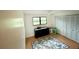 Bedroom featuring wood floors, window, ceiling fan, and large closet at 945 College Hill Dr, Clearwater, FL 33765